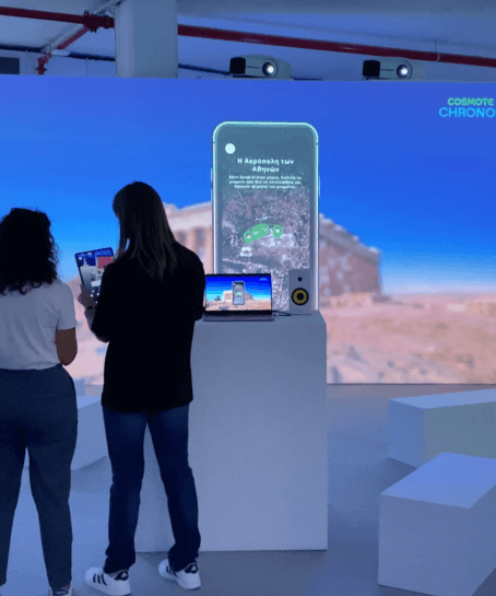 People experiencing the technology at an exhibition kiosk with projections